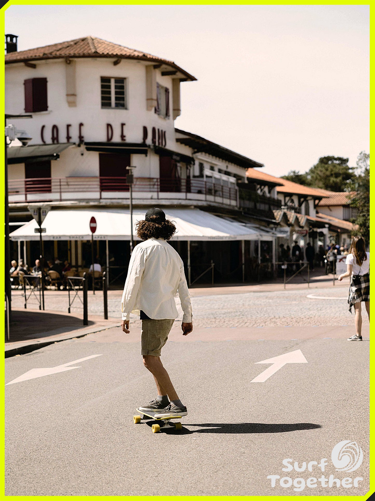 Estilo de Vida | Slide Gussie Spoon 31" SurfSkate | Chico sobre SurSkate frente a Cafe de Paris